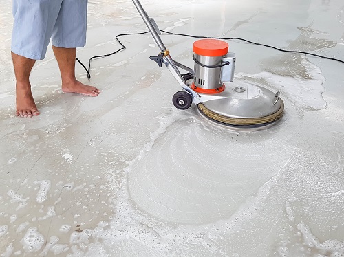 Industrial cleaner cleaning concrete floor